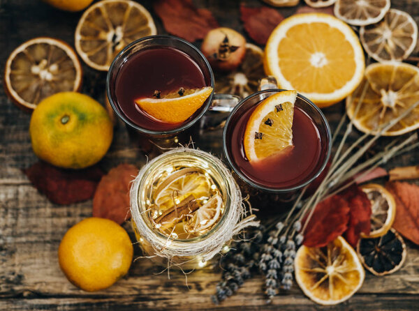 Hot mulled wine with dry orange slices, lavender and cinnamon st