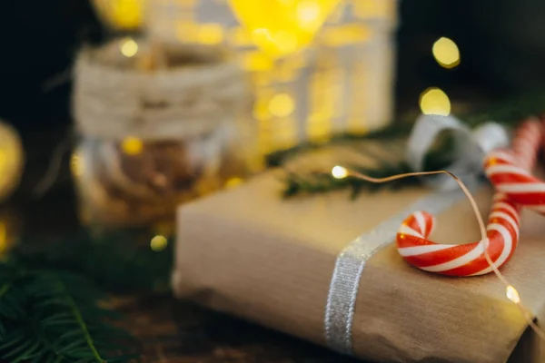 Regalo de Navidad con bastones de caramelo y rama de abeto en w oscuro —  Fotos de Stock