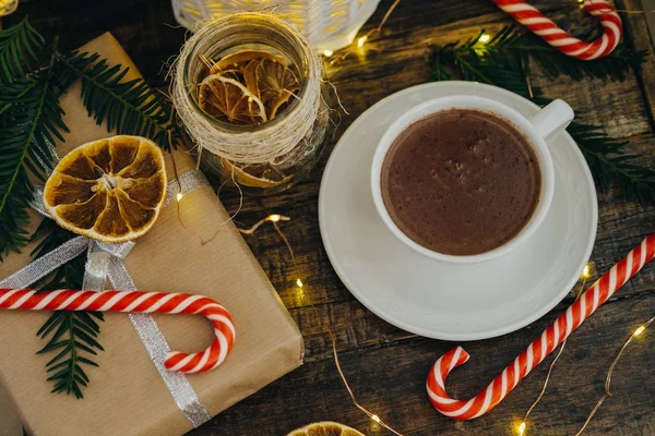 Closeup Hot chocolate with present, candy canes and Fir tree bra — Stock Photo, Image