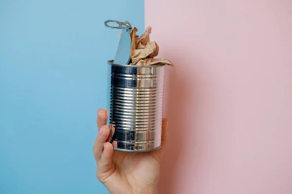 Hand with can on a pink background. separate garbage collection — Stock Image Hand with can on a pink background. separate garbage collection Stock Picture