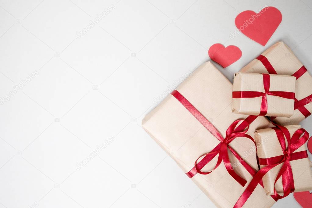 Valentine day background with gift boxes, red ribbon and hearts 