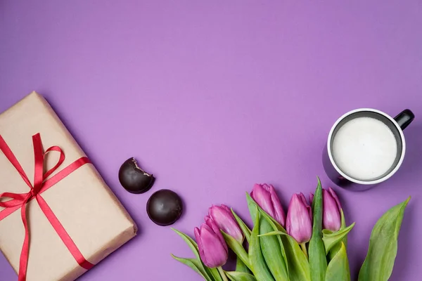 Tulipes violettes, café et bonbons sur fond violet. Printemps — Photo