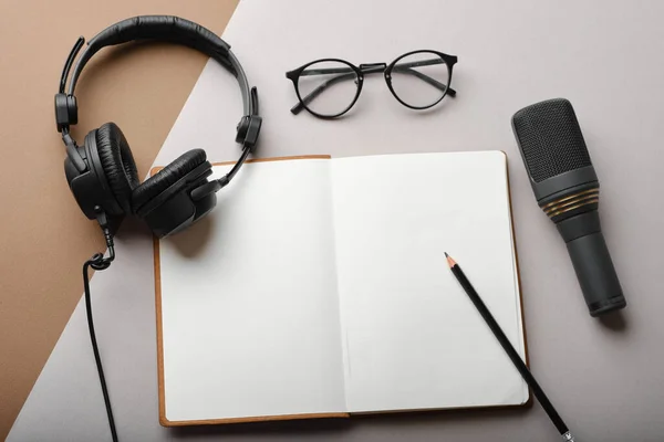 Flat lay composition with Microphone for podcasts  and black studio headphones on brown background with coffee and laptop, learning online education concept