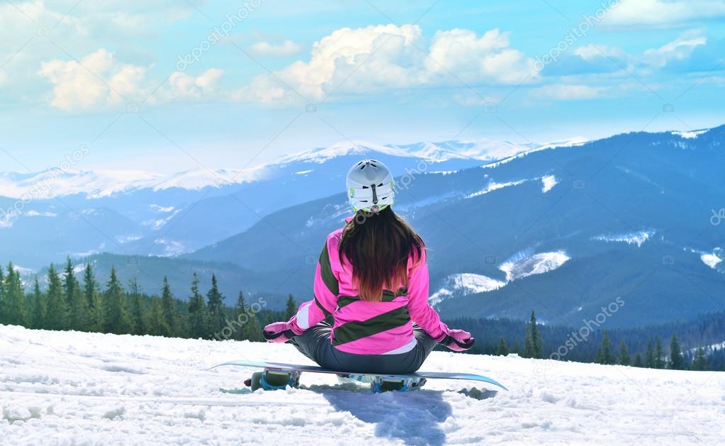 The young beautiful woman in mountains in winter meditation, yoga