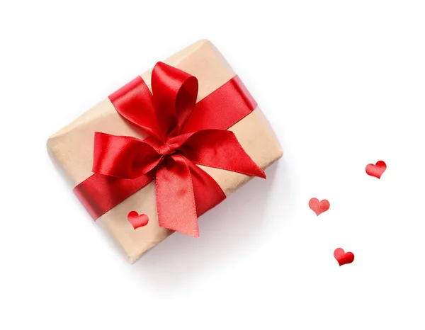 Geschenk mit roter Schleife auf weißem Hintergrund — Stockfoto