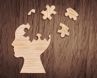 Human head silhouette with a jigsaw piece cut out clipart