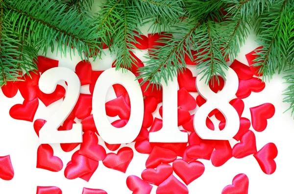 Happy new year. 2018 numbers on red hearts background.