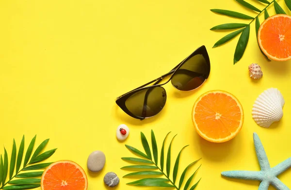 Fondo Tropical Summer Beach. Palmeras Ramas, alquitrán, concha, gafas de sol y naranja sobre fondo amarillo veraniego. Viajar. Concepto de verano . —  Fotos de Stock