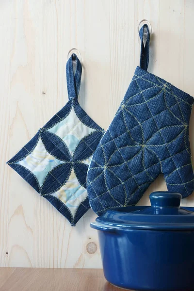 Kitchen potholders on hooks — Stock Photo, Image