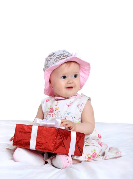 Adorable baby girl with gifts — Stock Photo, Image