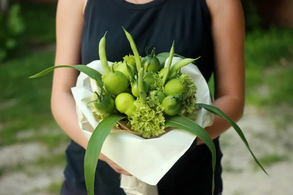 A bouquet of vegetables and fruits for a gift to a woman