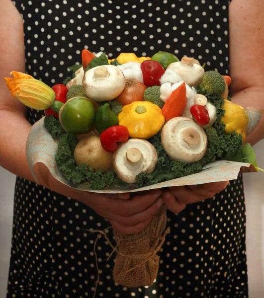 A bouquet of vegetables and fruits for a gift to a woman