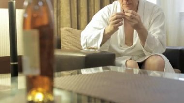 a man in home clothes twists a ring in his hands and is nervous