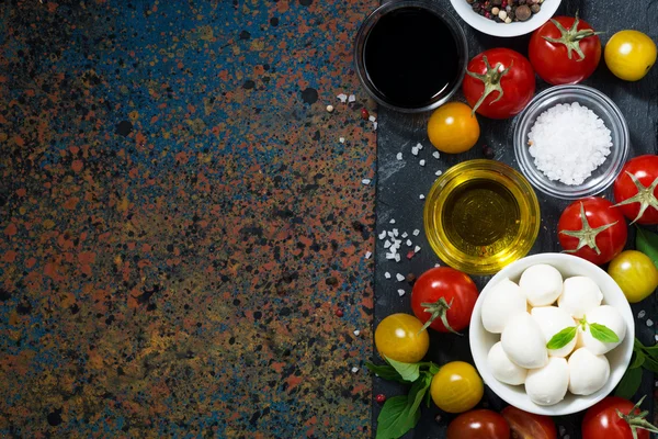 Mozzarella, świeże warzywa i przyprawy i ciemne tło — Zdjęcie stockowe