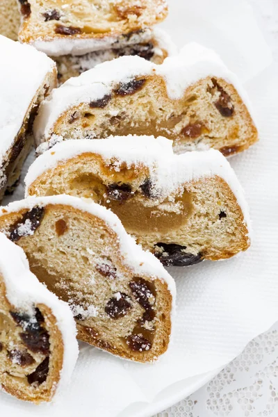 Christmas Stollen with marzipan on a plate, closeup vertical — Stock Photo, Image