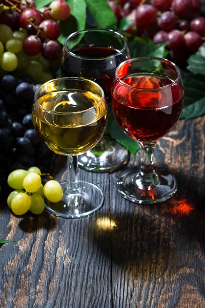 Assortment of wine on wooden background, vertical — Stock Photo, Image