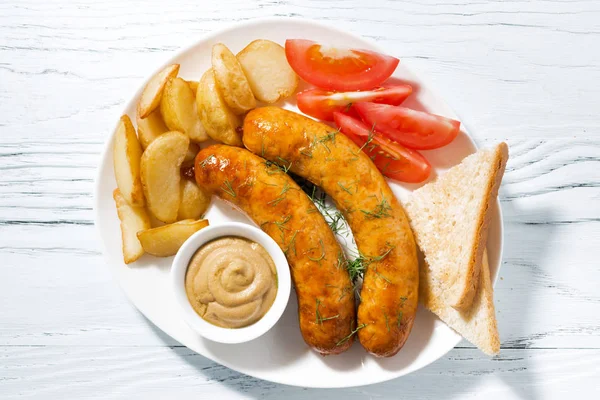 Fried sausages with potatoes and mustard, top view — Stock Photo, Image