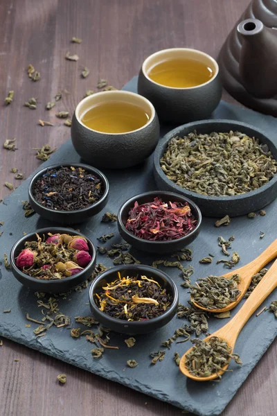 Assortment of dry tea in bowls, vertical, top view — Stock Photo, Image