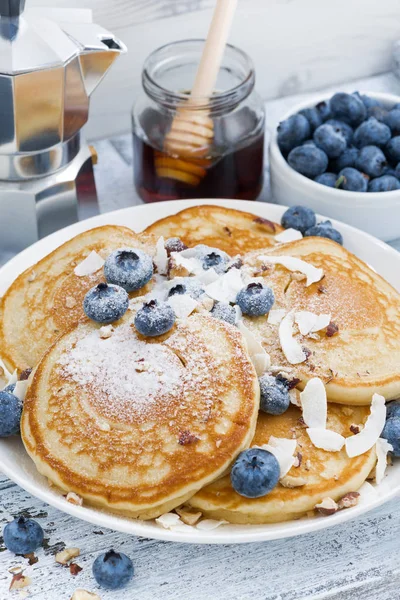 Tortitas sabrosas con arándanos frescos y miel para el desayuno —  Fotos de Stock