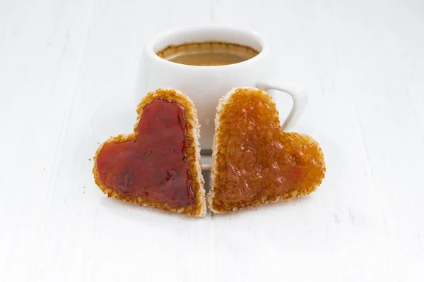 Toasts in heart shape with fruit jam and cup of coffee — Stock Photo, Image