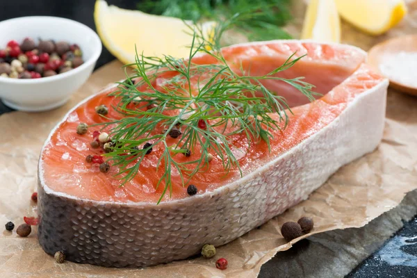 Fresh salmon steak, lemon and spices prepared for cooking — Stock Photo, Image