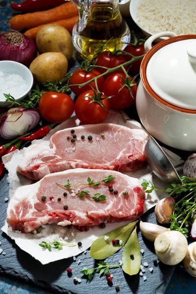 Two pieces of raw pork and ingredients for preparation of soup — Stock Photo, Image