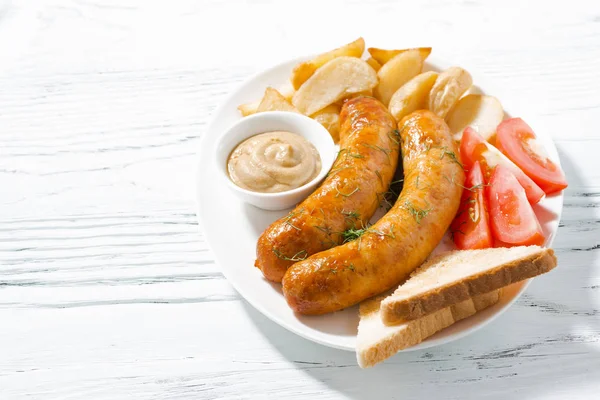 Fried pork sausages with potatoes and mustard — Stock Photo, Image