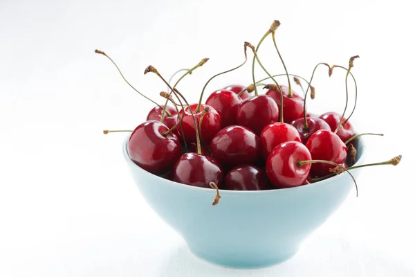 Bowl of fresh cherries on a white background, closeup — Stock Photo, Image