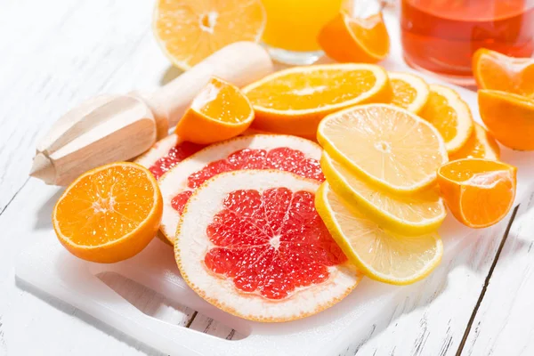 Assortment of fresh citrus on a white board — Stock Photo, Image