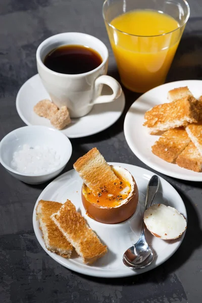 Soft boiled egg, toasts, cup of coffeeand orange juice — Stock Photo, Image