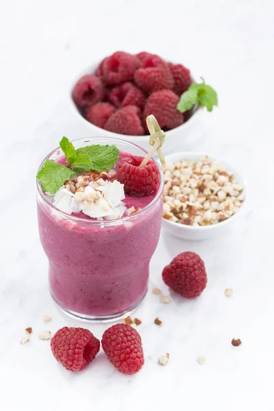 Fresh raspberry smoothie with nuts on a white background — Stock Photo, Image
