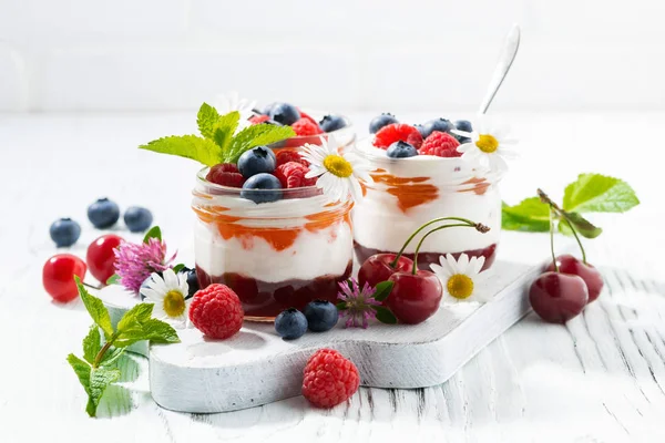 Sweet dessert with jam and cream on white wooden board — Stock Photo, Image