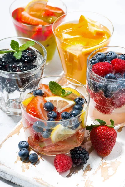 carbonated drinks with berries and fruits, vertical