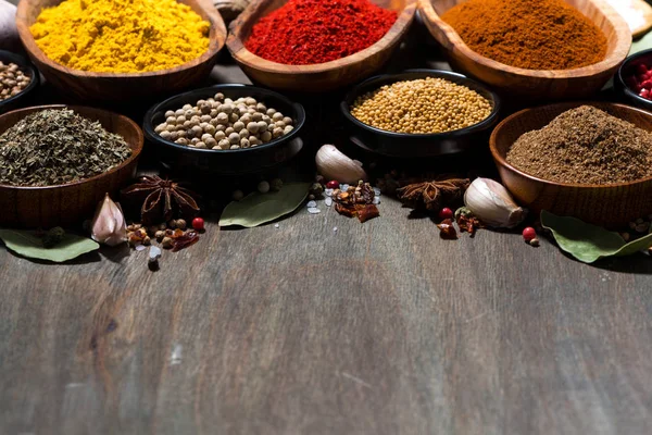 Assortment of spices on a wooden background — Stock Photo, Image