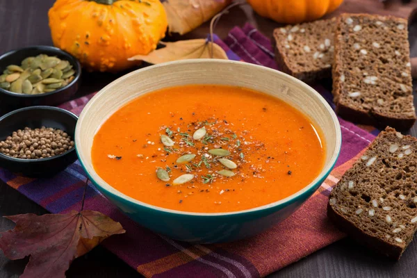 Sopa de calabaza en un tazón en la mesa de madera, primer plano — Foto de Stock