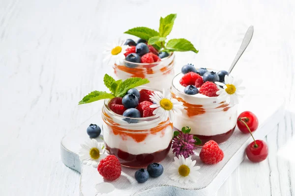 Sweet dessert with jam, cream and fresh fruit — Stock Photo, Image