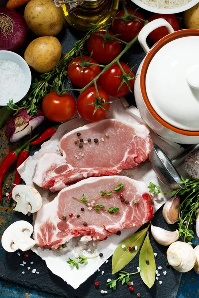 Two pieces of raw pork and fresh ingredients — Stock Photo, Image