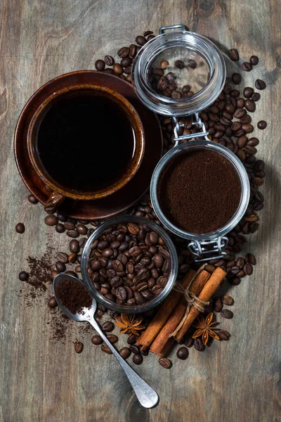 Roasted coffee beans and spices on dark wooden background — Stock Photo, Image