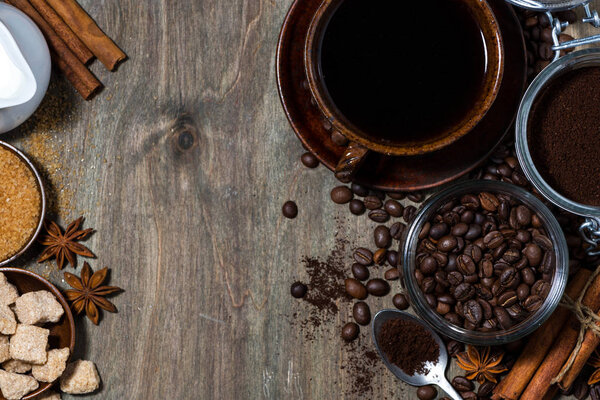 roasted coffee beans and spices on wooden background