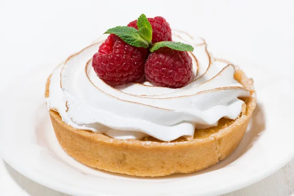 Sweet tartlet with meringue and raspberry on white plate — Stock Photo, Image