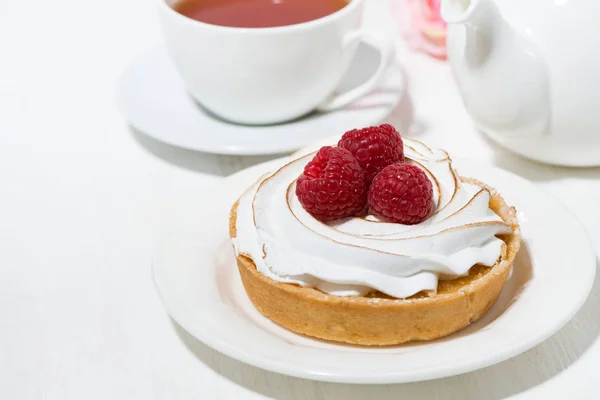 Sweet tartlet with meringue and raspberry on white table — Stock Photo, Image