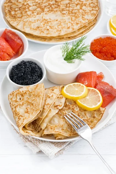 Crepes with fish, sour cream and caviar, vertical, top view — Stock Photo, Image
