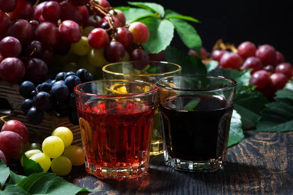 Assortment of grape juice on wooden background, closeup — Stock Photo, Image