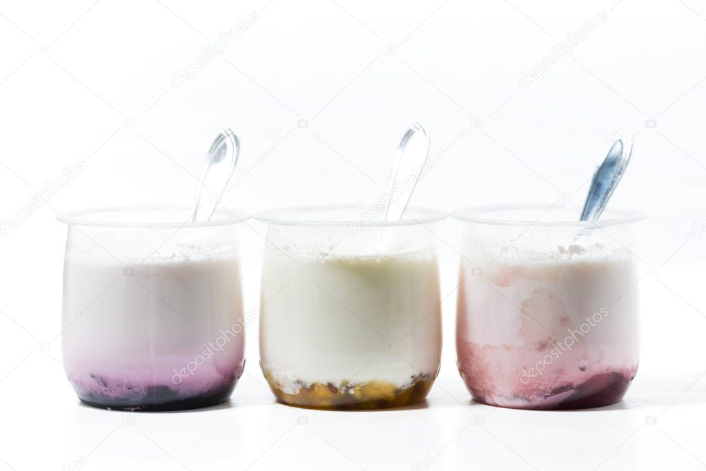 assortment of yogurts with fruit additives on white table