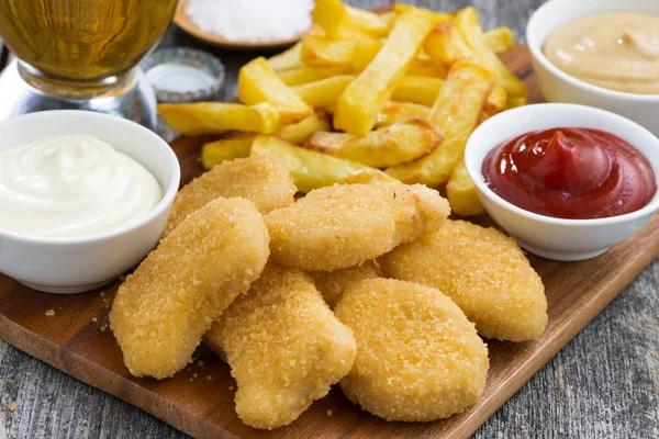 Chicken nuggets with french fries and different sauces, closeup — Stock Photo, Image