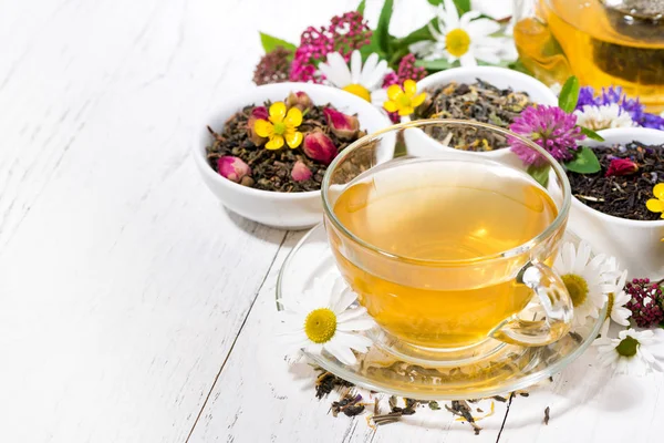 Fragrant herbal tea in a cup on white wooden background — Stock Photo, Image