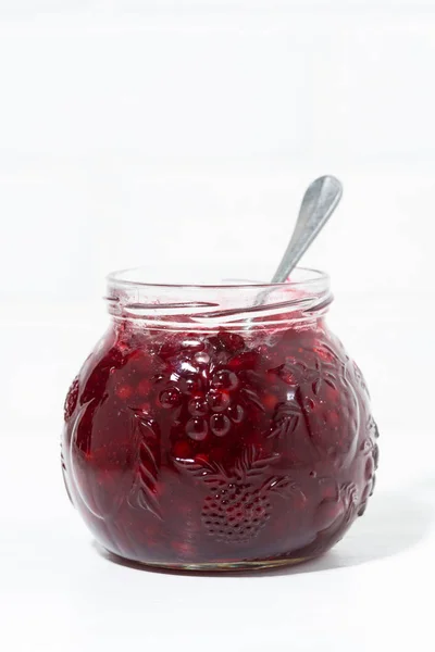 Jar with cowberry jam on white background, vertical — Stock Photo, Image