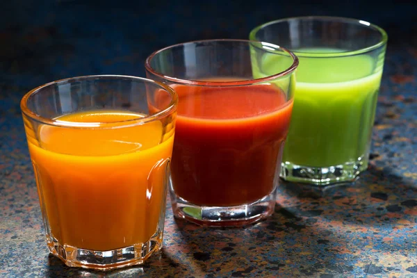 vegetable juices in glass beakers, closeup