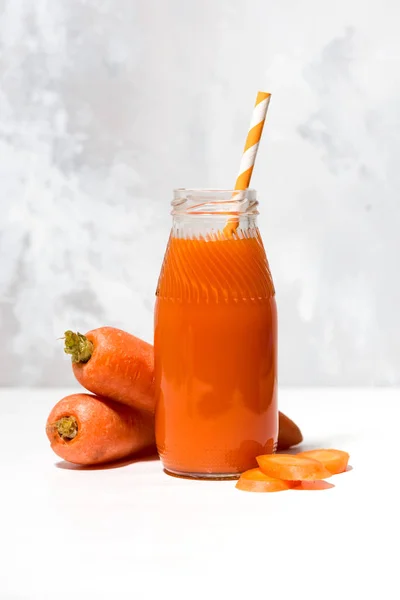 Fresh carrot juice in a bottle, vertical — Stock Photo, Image