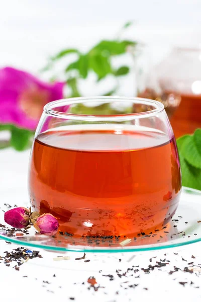 Tea with wild rose in a glass cup on a white background — Stock Photo, Image